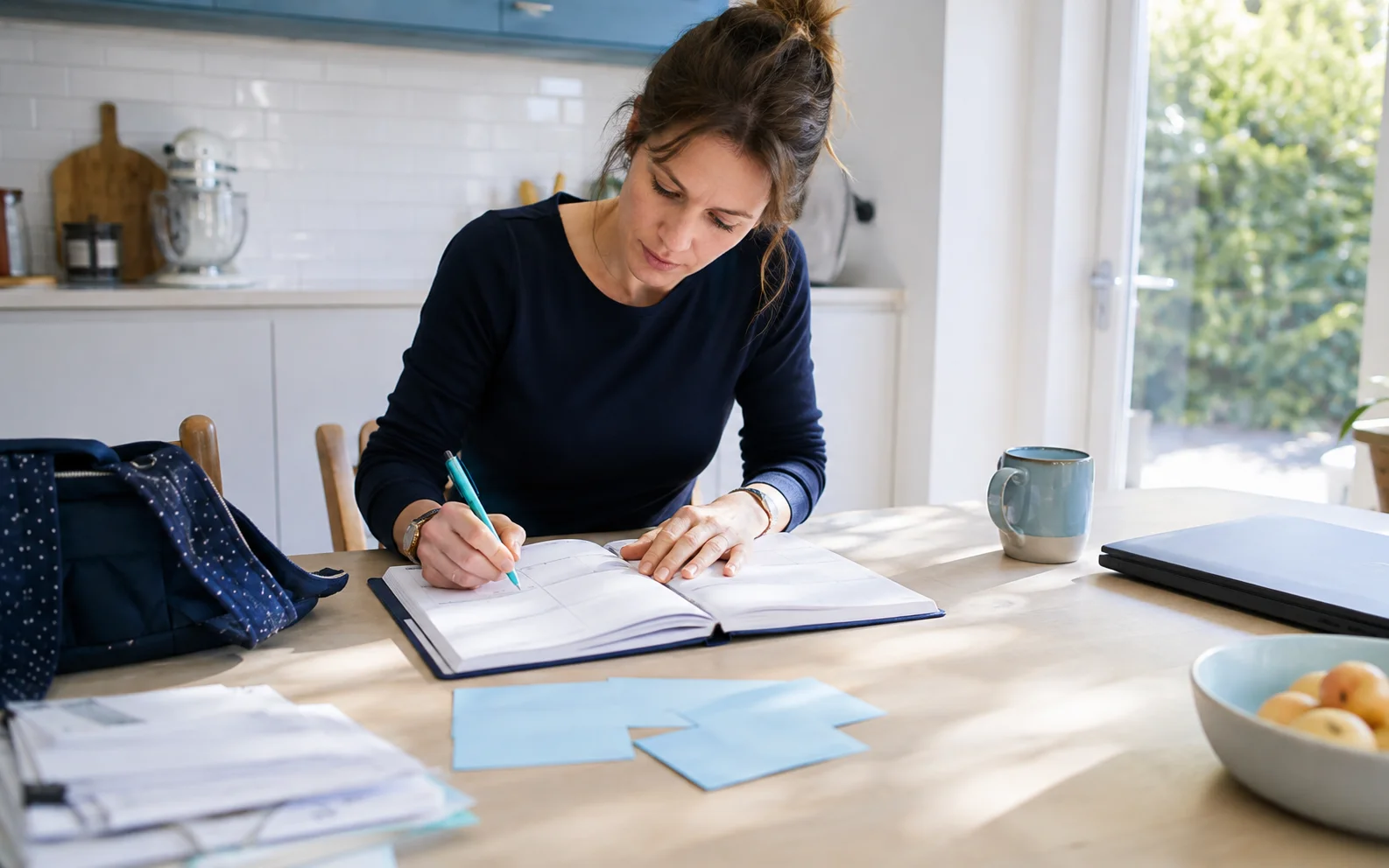 A woman planning her week with appointment cards and a paper planner